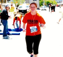 Woman smiles during a run race.