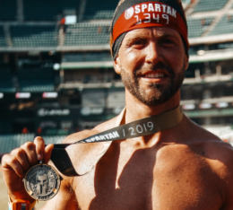 Henry poses with his Spartan race finisher medal.