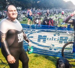 Male athletes in wetsuit poses in transition before Aquathlon Nationals.